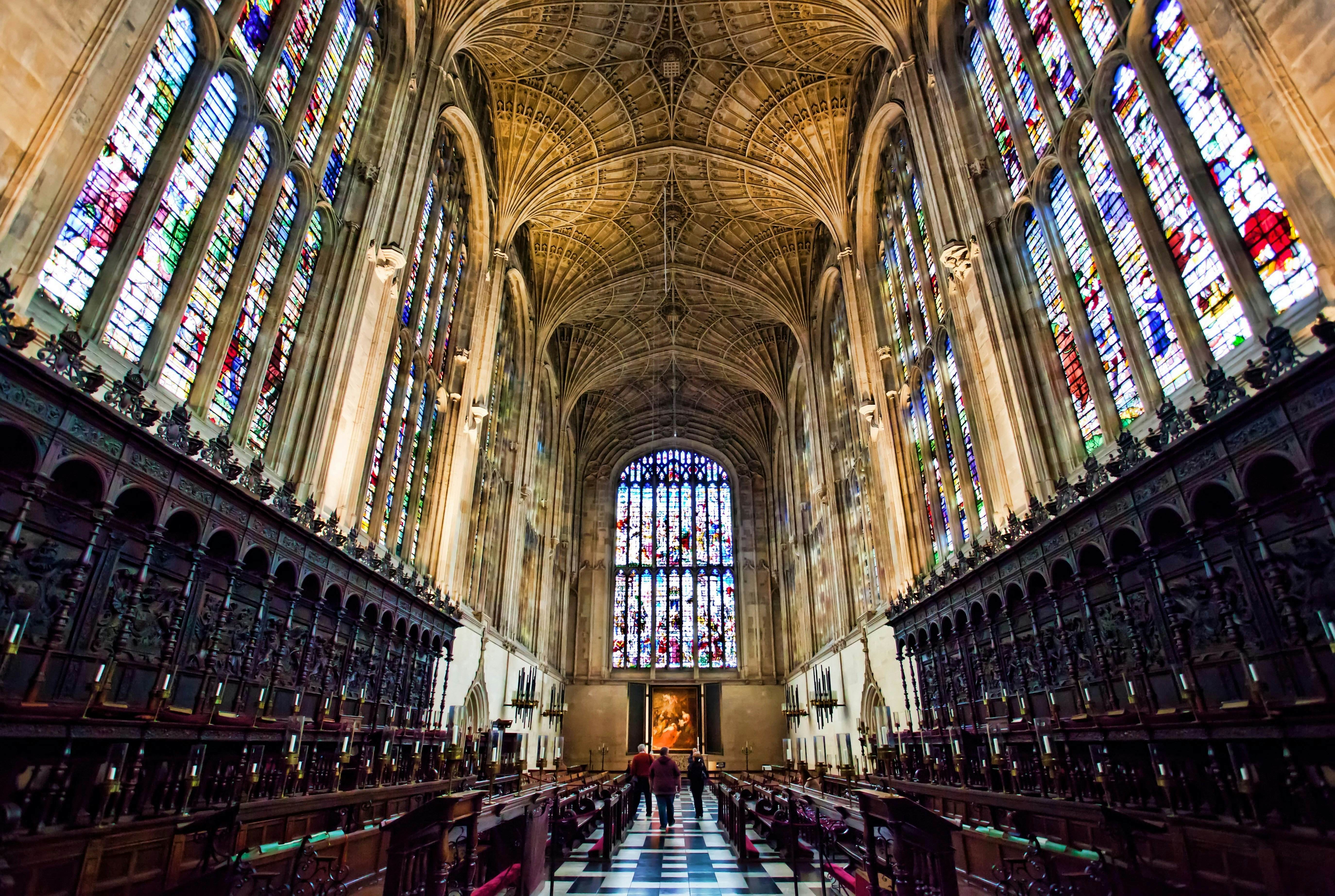 View inside Kings college Chapel Cambridge, showing the fan vault ceiling and vast wooden paneling, and amazing stain glass windows.